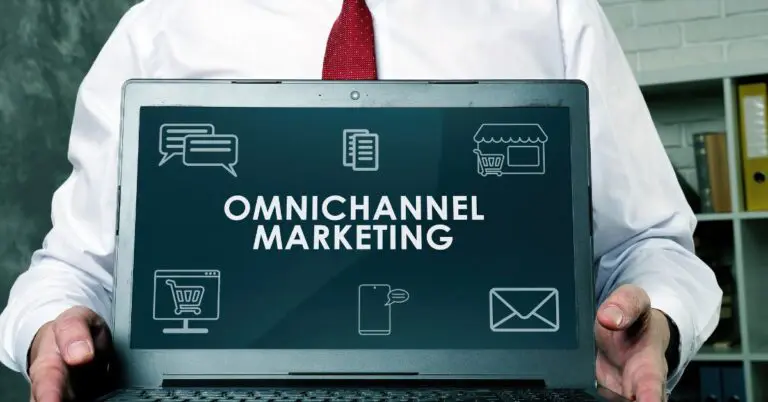 a person holding a laptop with the words omnichannel marketing strategy on it