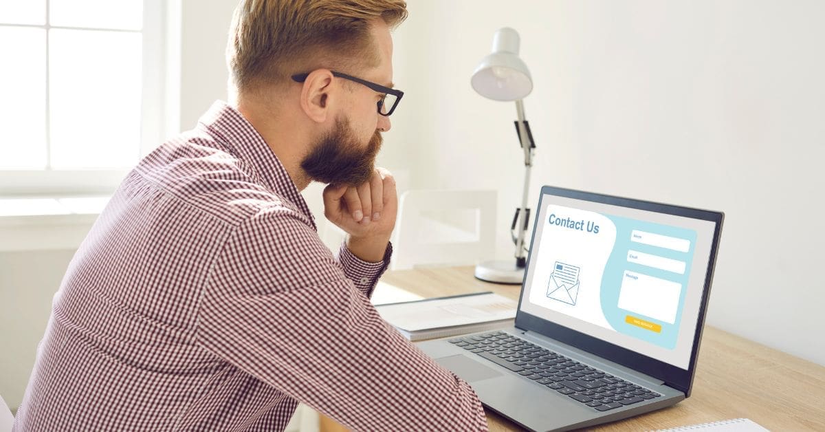 person looking at a landing page on his laptop