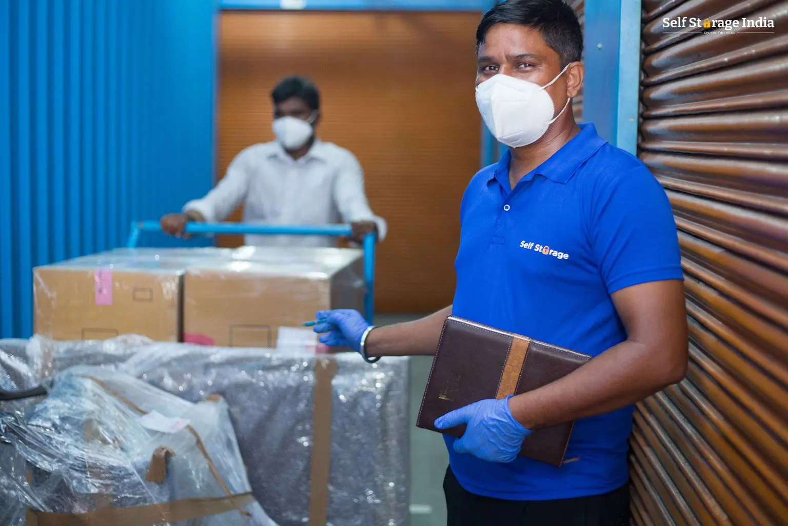 Self Storage India staff member helping a customer move their goods into their secured storage