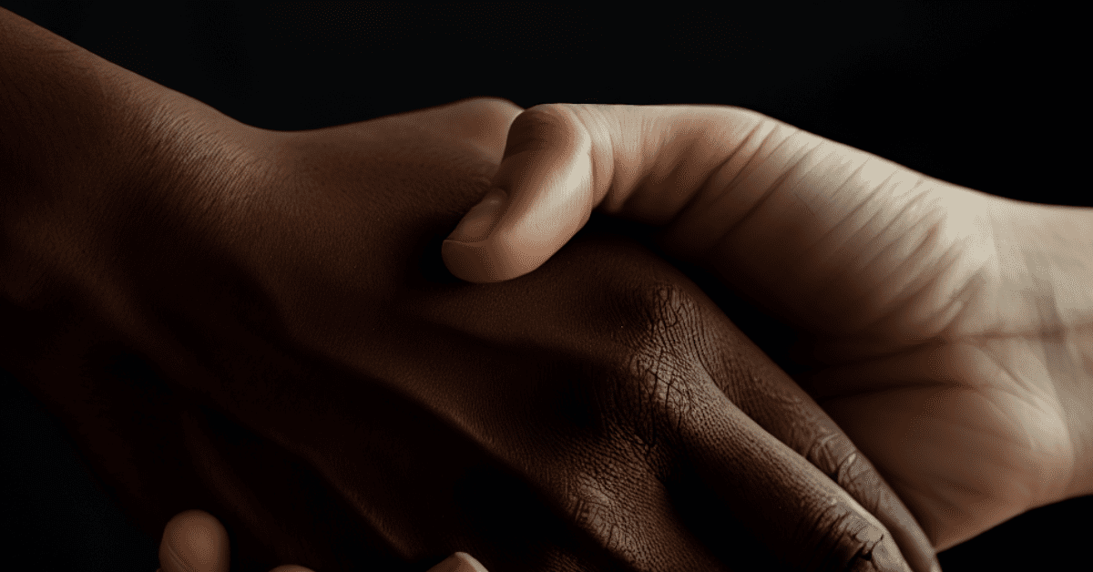 a woman and a man shaking hands to signify an agreement. focus on the hands only, faces are not visible.