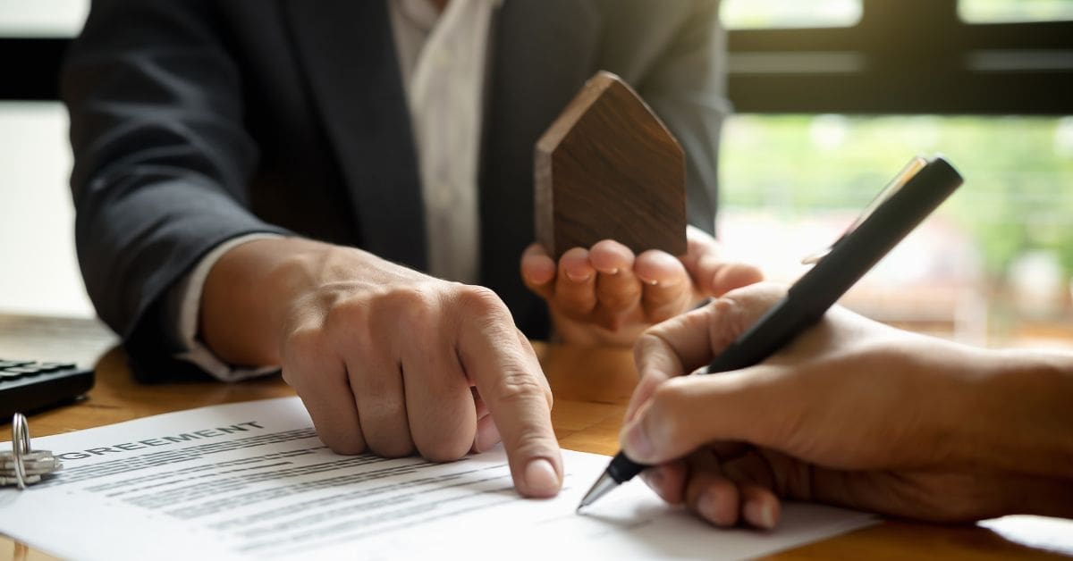 a salesperson helping a potential customer to fill out and persuading them to sign an agreement